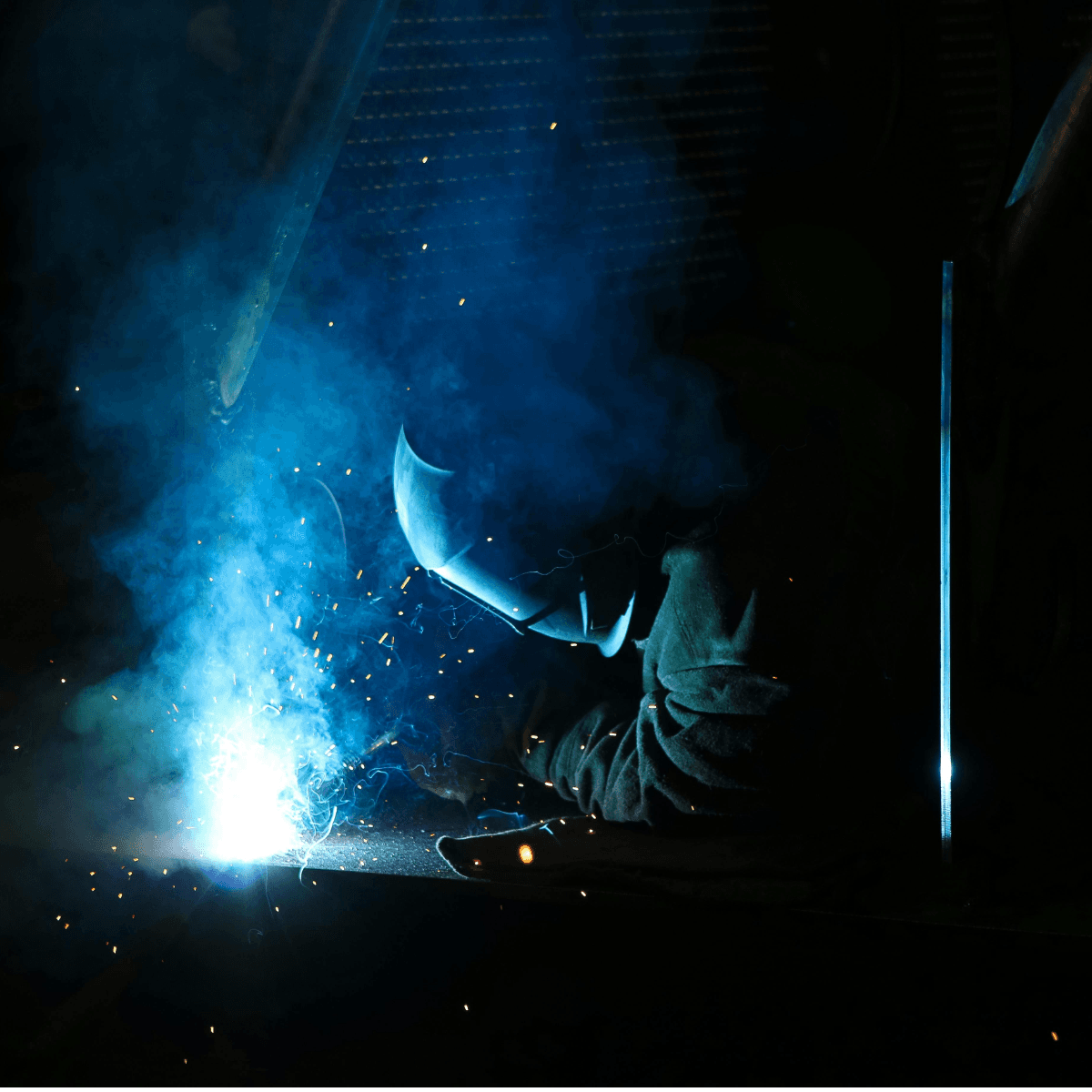 Certified welder performing special process weld work with sparks and arc light